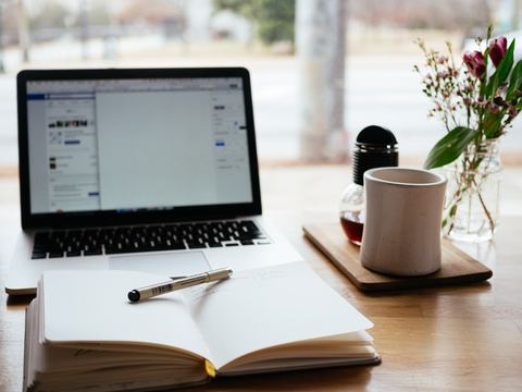 Desk with computer and book open